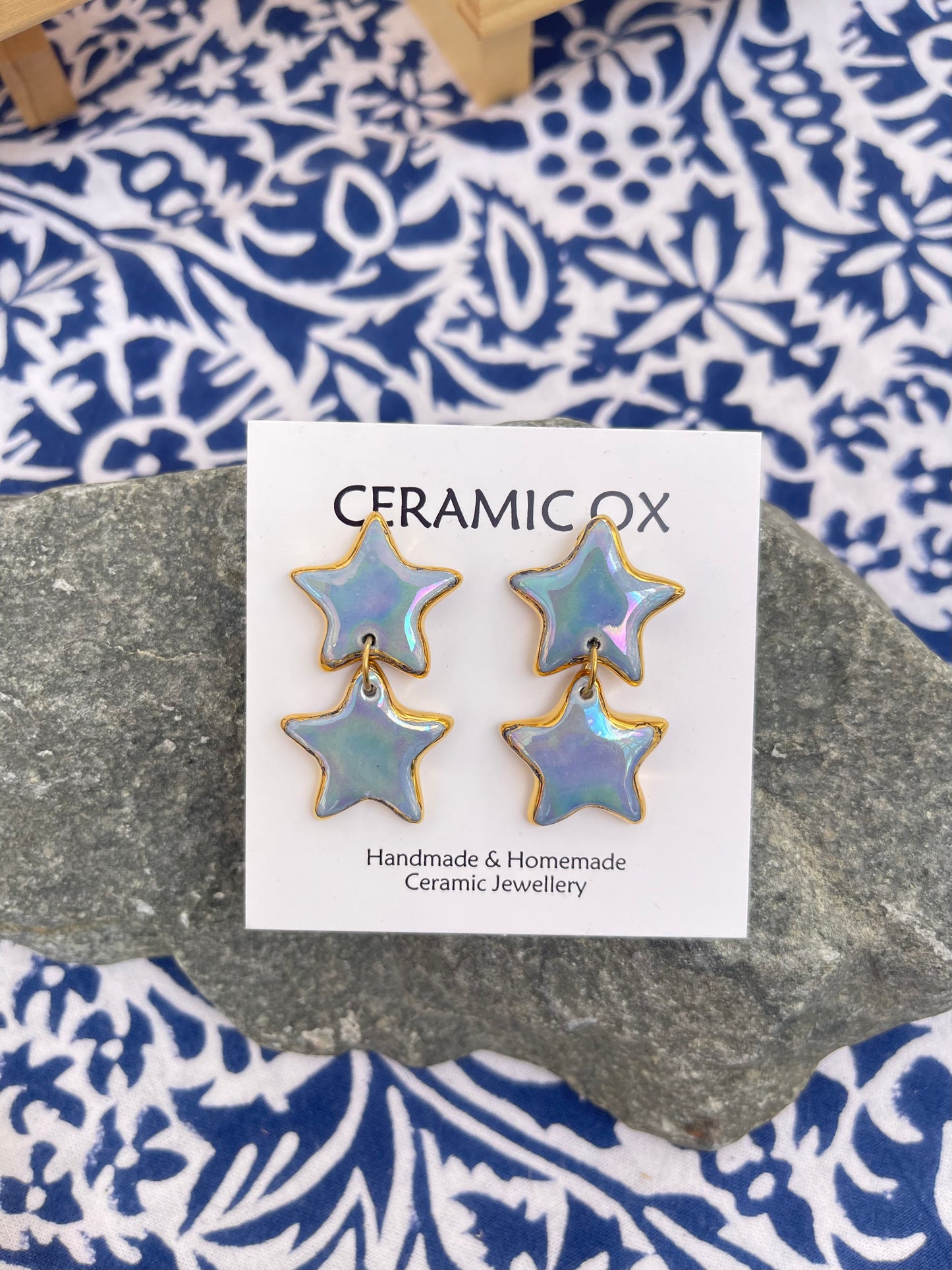 Iridescent double star dangle studs